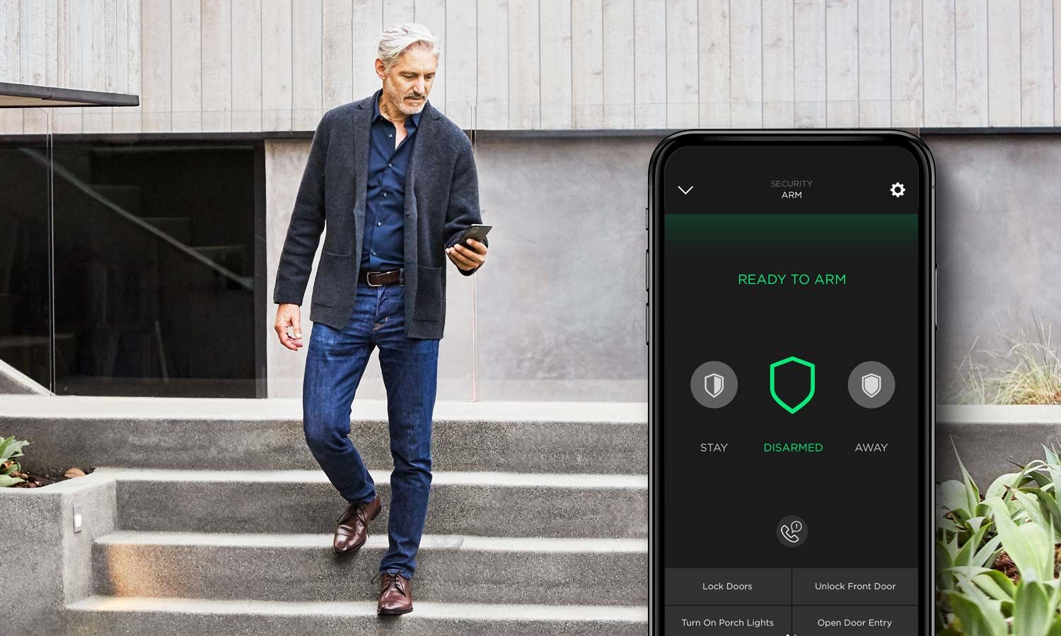 man checking his phone while walking down the stairs