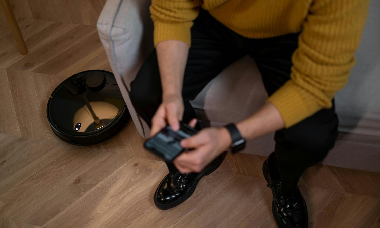man checking his phone while walking down the stairs