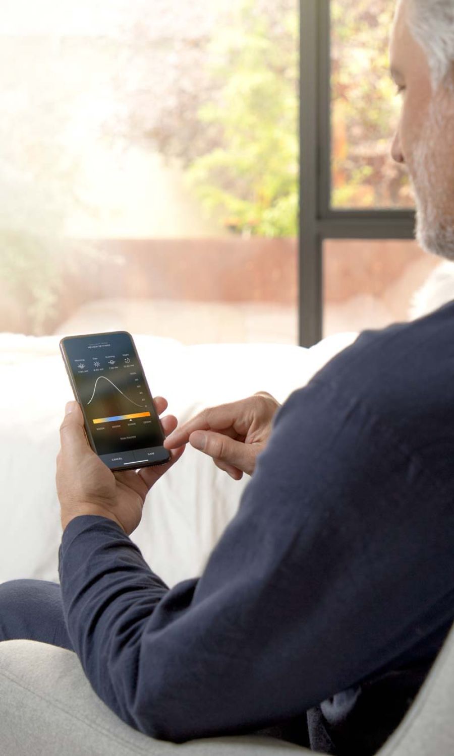 Man checking lighting control statistics on his phone